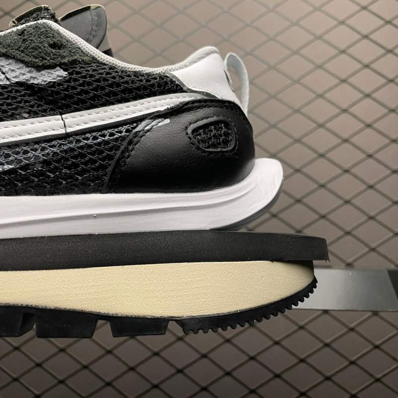 1742778734 989 Nike sacai x nk vapapaffle 30 black and white bneakers